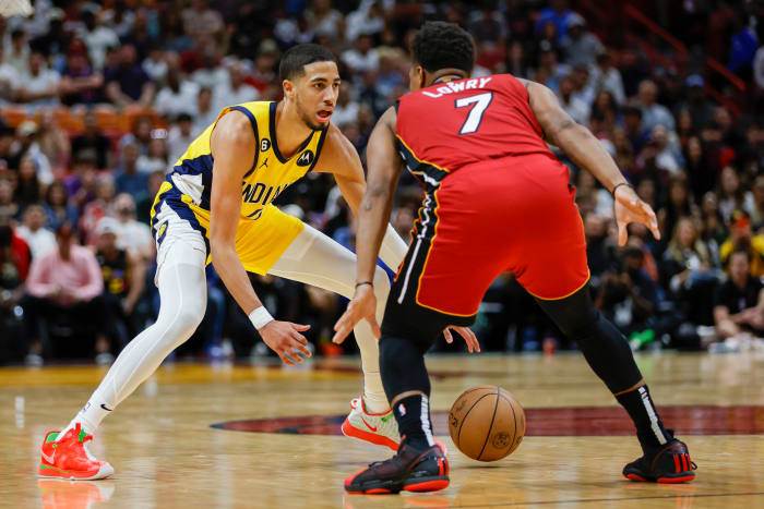 Pacers guard Tyrese Haliburton dribbles around Heat guard Kyle Lowry.